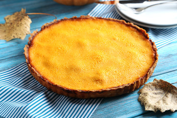 Tasty pumpkin pie on a blue wooden table