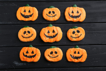 Fresh halloween gingerbread cookies on black wooden table