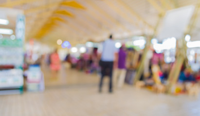 Obraz premium Blurred image of people walking at day market