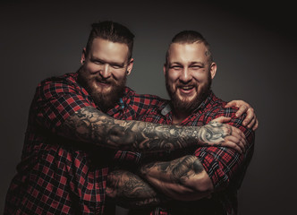 Two smiling brutal bearded males.