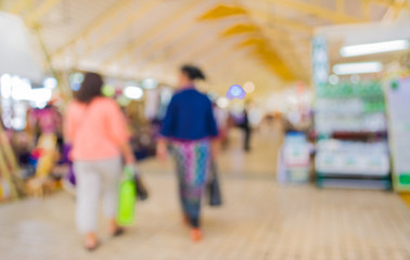 Blurred image of people walking at day market