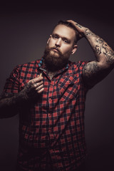 Tattooed man with beard  in red t shirt.