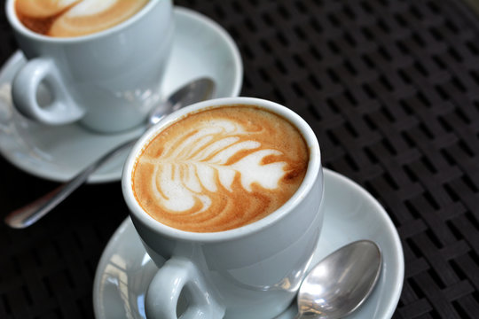 White Cup Of Foamy Cappuccino On A Black Background