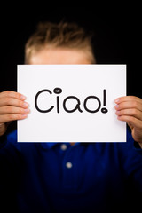 Child holding sign with Italian word Ciao - Hello