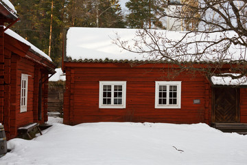 Old-fashioned cottage painted in swedish traditional red color.