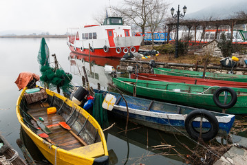Fototapeta na wymiar Traditional wooden fishing boats in Lake Pamvotis near Ioannina, Greece
