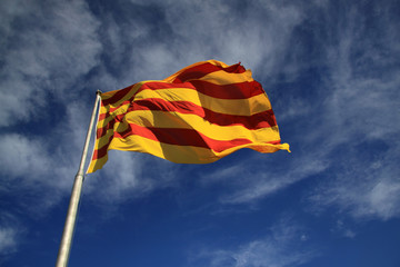 BARCELONA, CATALONIA, SPAIN - AUGUST 31, 2012: Catalan flag fluttering in the wind - obrazy, fototapety, plakaty
