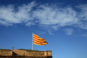 BARCELONA, CATALONIA, SPAIN - DECEMBER 14, 2011: Catalan flag fluttering in the wind in Montjuic Castle