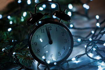Fototapeta na wymiar Alarm clock and christmas lights
