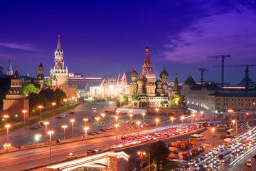 Fototapeta na wymiar Night aerial panorama to Bolshoy Moskvoretsky Bridge, Vasilevsky Descent, towers of Moscow Kremlin, Saint Basil Cathedral, GUM and evening traffic jam