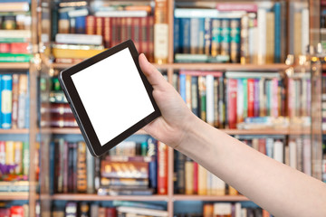 hand holds tablet pc in library background