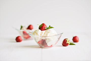 Ice cream with strawberries in the shape of a glass on the table