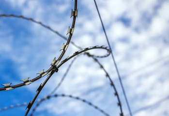 Barbed wire against the blue sky
