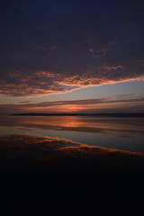 Fototapeta premium St.Aubin's Bay, Jersey, U.K. Autumn sunset reflected in a still pool of water.