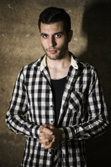Man with cool plaid shirt posing in studio shot