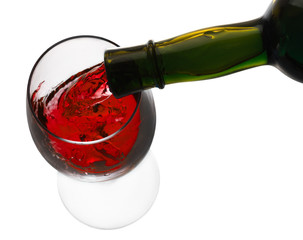 red wine pouring in glass isolated on white background