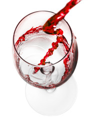 red wine pouring in glass isolated on white background