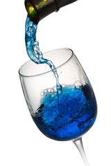 blue alcohol drink pouring in a glass isolated on the white back