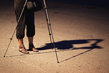Photographer photographs from a support at night
