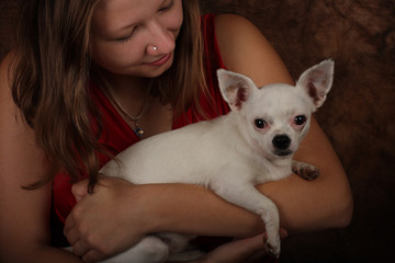 Portrait of young woman with white chihuahua