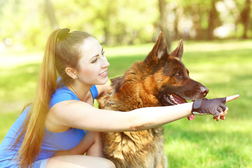 Beautiful young girl with dog in park