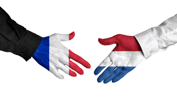 France and Netherlands leaders shaking hands on a deal agreement