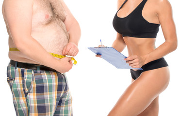 Coach holds the client waist measurement