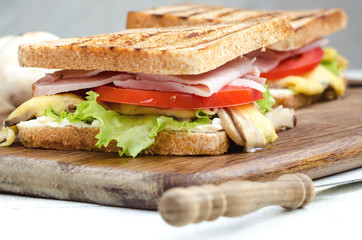 Tasty healthy sandwiches at white wooden table. Rustic style. Shallow focus