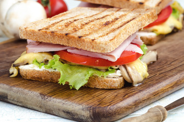 Tasty healthy sandwiches at white wooden table. Rustic style.