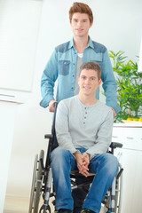 Teenager in wheelchair and his friend