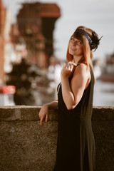 Flapper girl woman in1920s style standing on the street