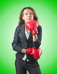 Young businesswoman in boxing concept