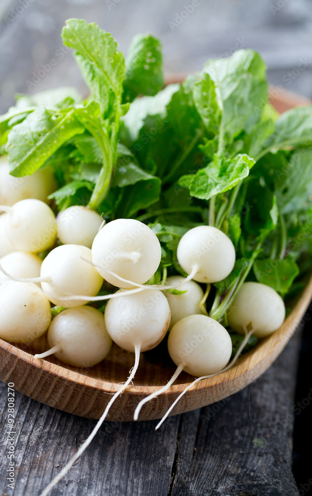 Poster white radishes on wooden surface