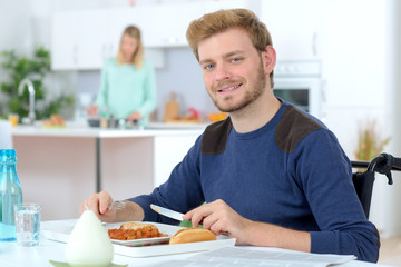 Disabled man eating his lunch