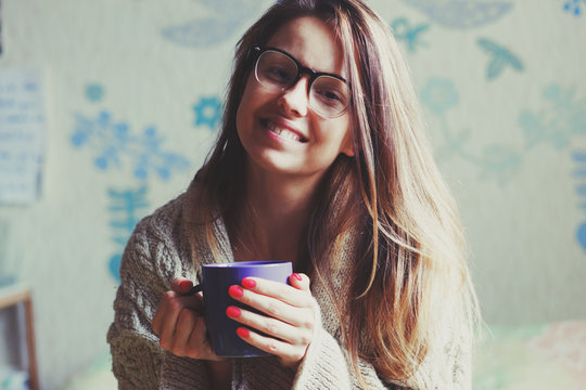 cheerful girl drinking coffee in bed