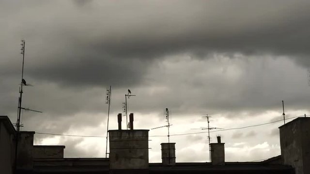 Dramatic skies over the roof tops, time lapse 4K