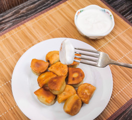 To dip the fried dumplings in sour cream