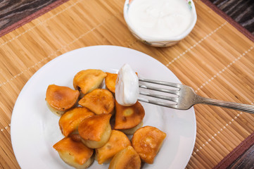 To dip the fried dumplings in sour cream