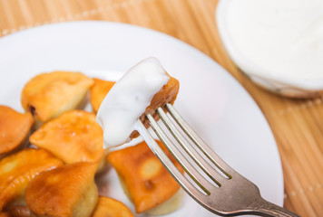 To dip the fried dumplings in sour cream