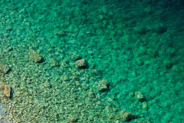 Rocky bottom in clear lake water