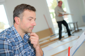 Builder checking his clipboard