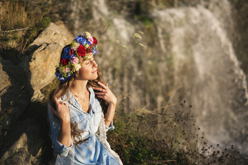 Portrait of a beautiful girl on a waterfall background