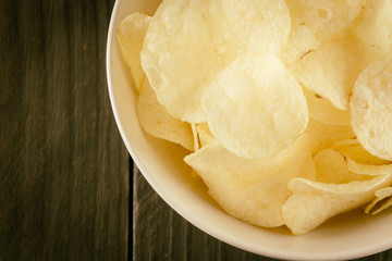 potato chips on wood - soft focus with vintage film filter