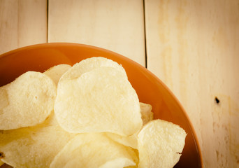 potato chips on wood - soft focus with vintage film filter