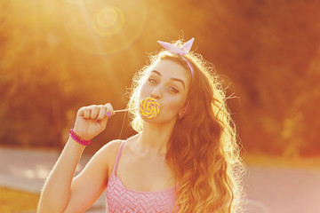Pin Up Girl hides her lips for a lollipop.