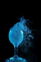 Aquamarine smoke in a glass. Halloween.