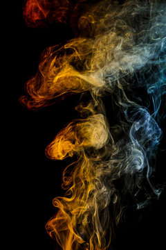 Orange - yellow - blue abstract smoke on black background.
