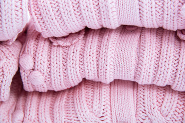 Stack of colorful cozy knitted sweaters