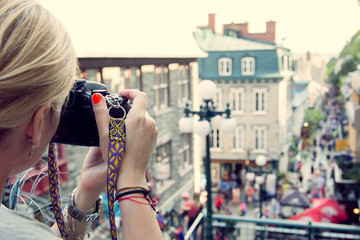 
Young woman taking pictures on the busy rue Petit Champlain in Quebec City, Canada. North...