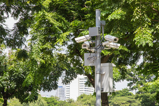 Four cctv security cameras on the street pylon.